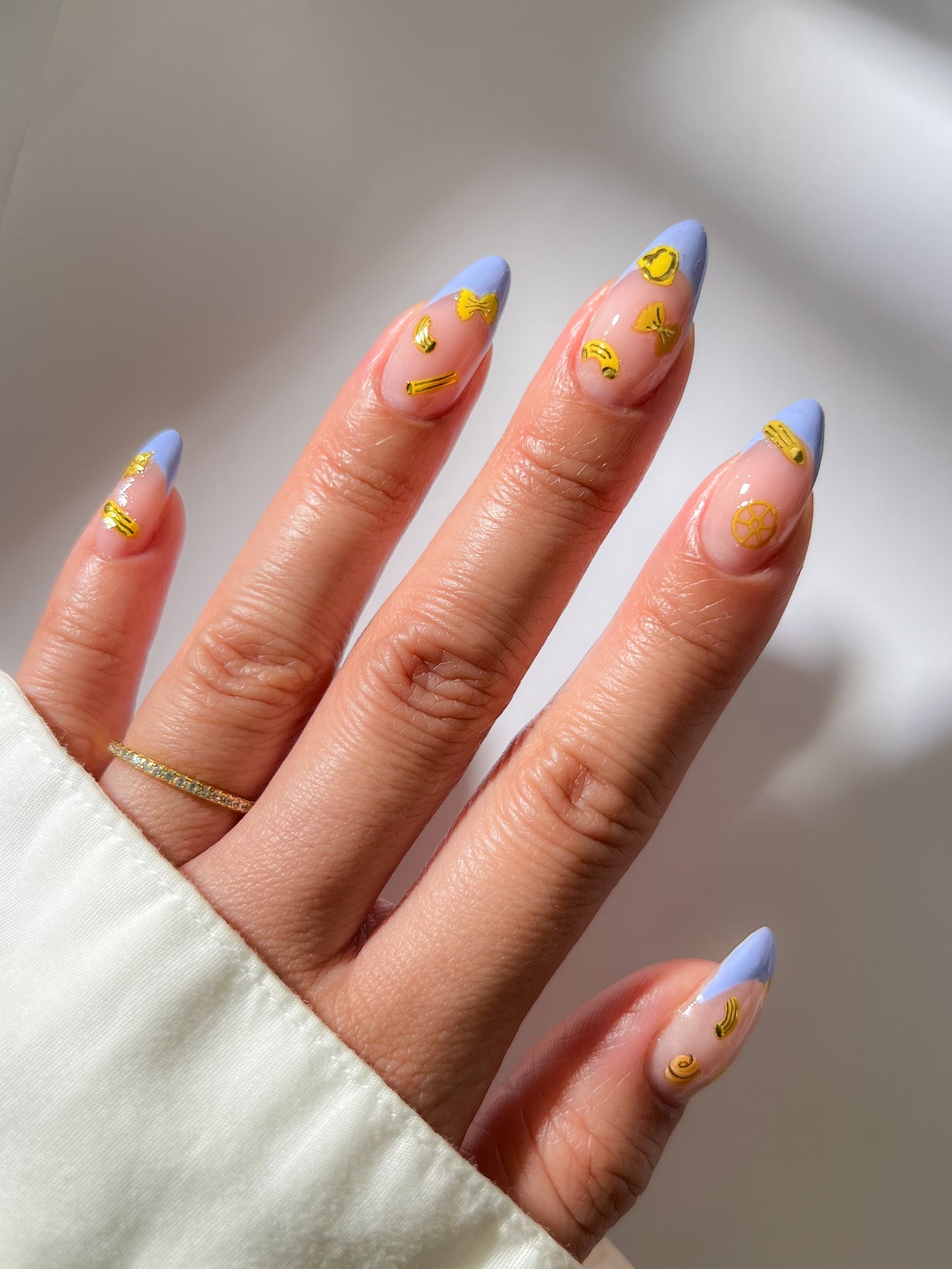 Light blue french tip nails with yellow stickers