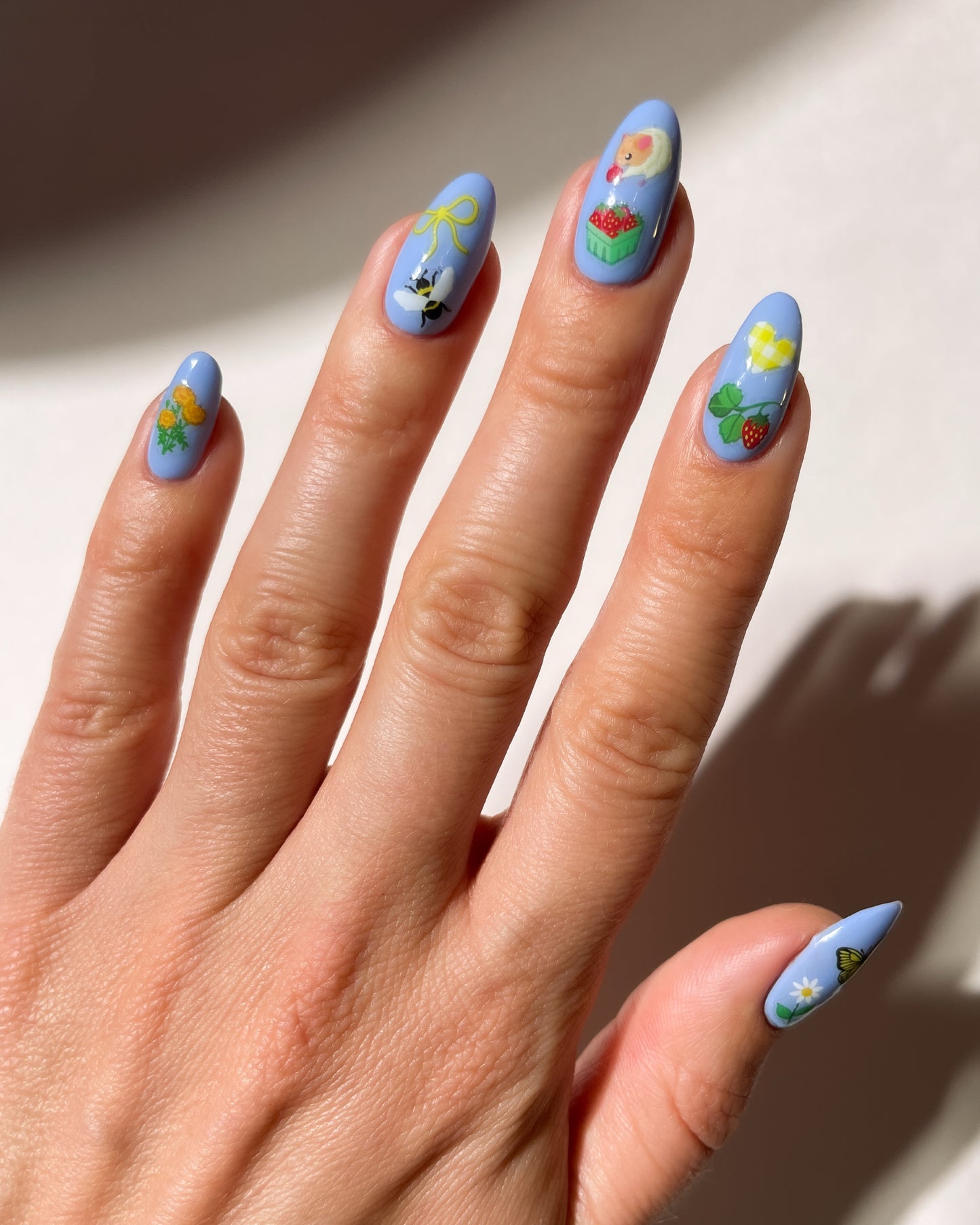 Berry Patch stickers on light blue nails