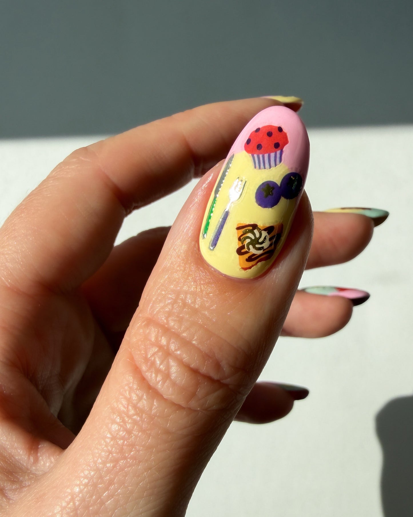Food nail art stickers on a pastel thumb nail