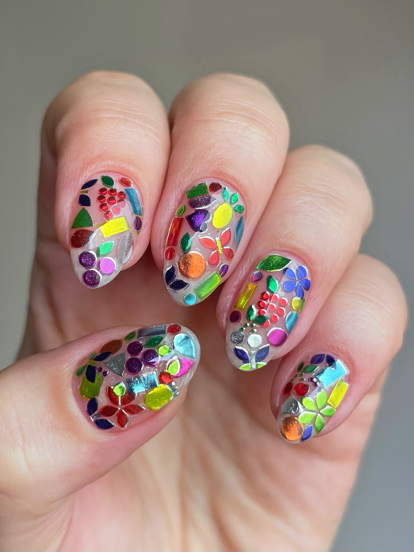 Tutti Frutti nail art stickers on bare nails topped with top coat.