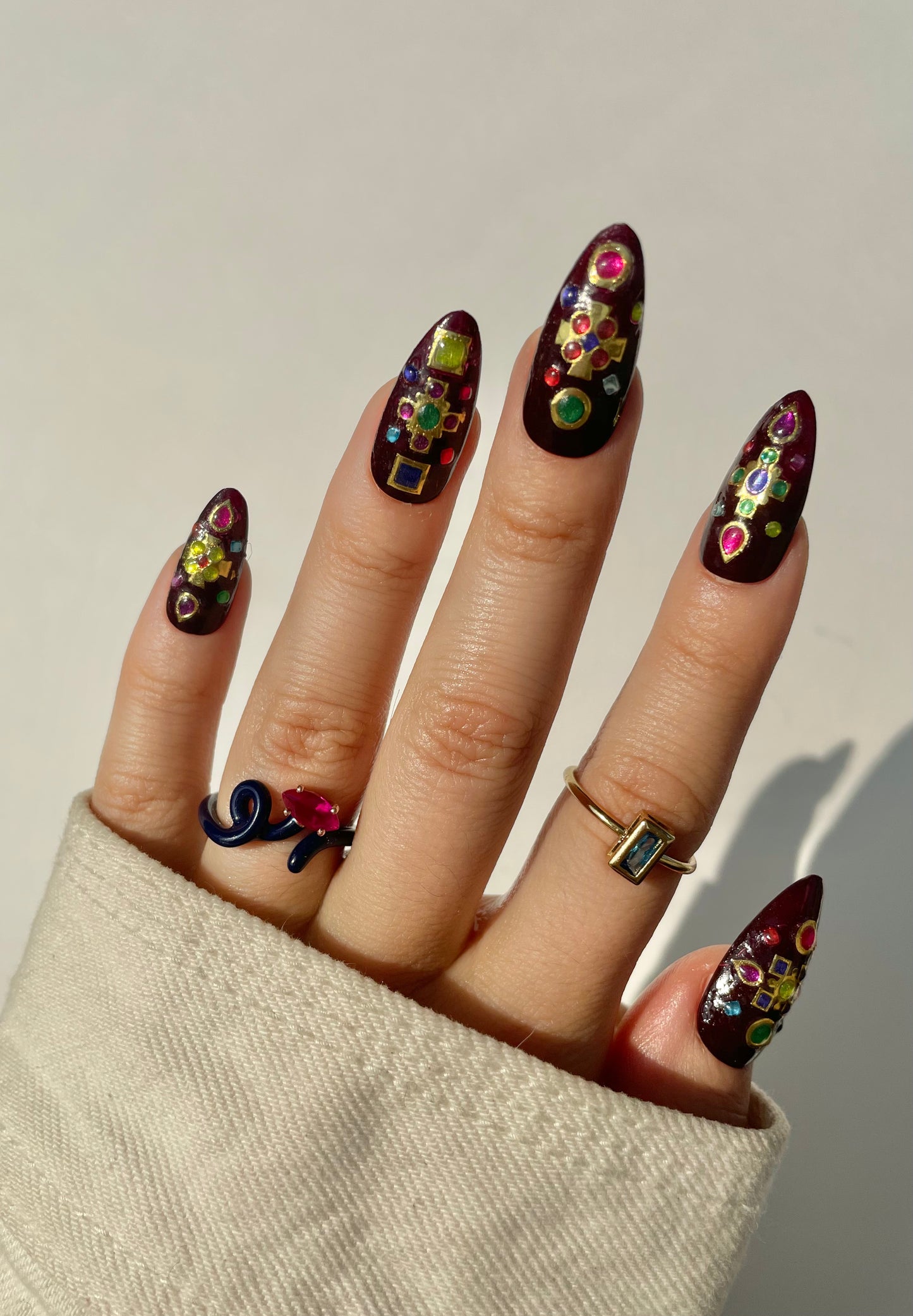 Bejeweled on dark red nails