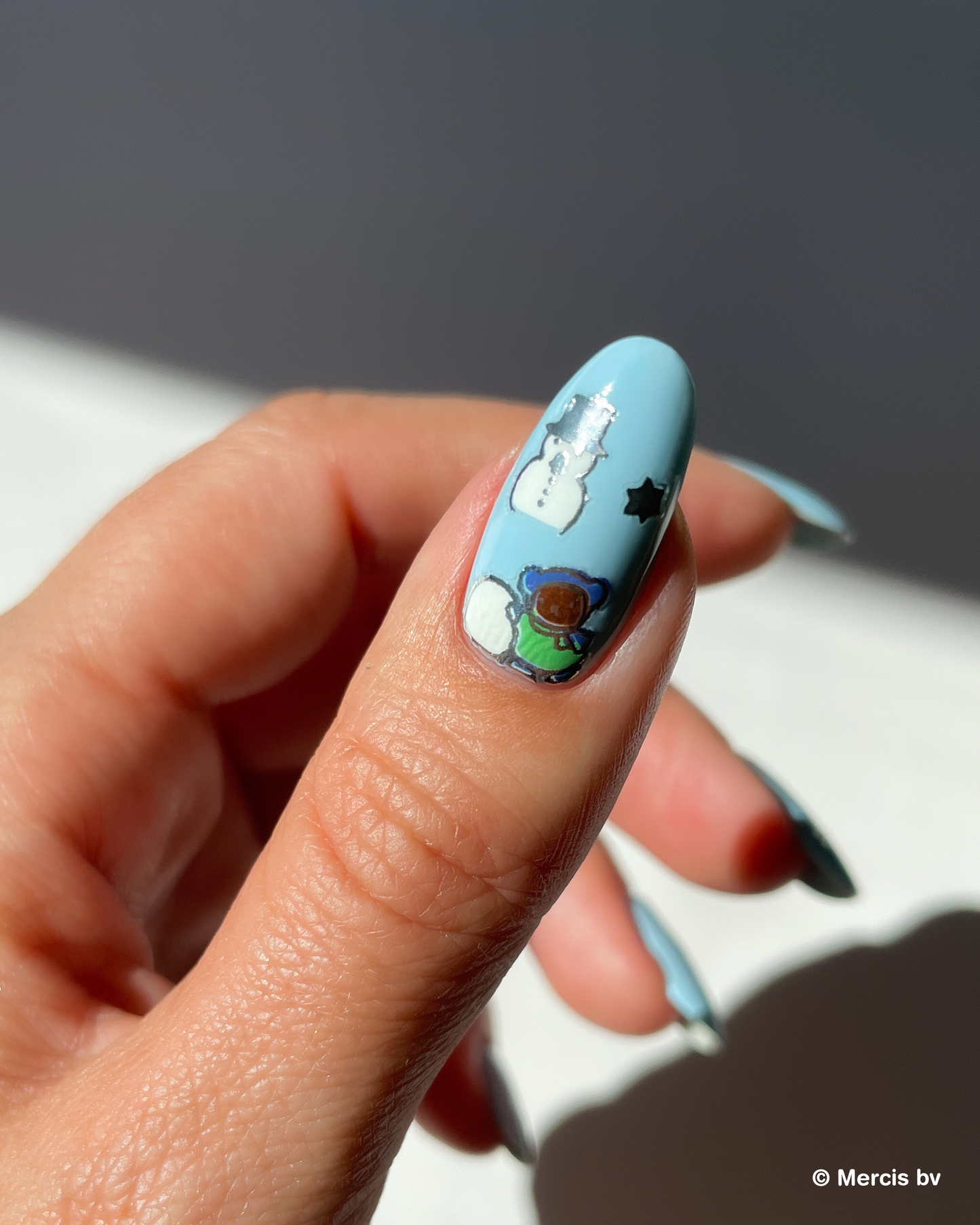 Nail with blue polish and miffy nail art sticker