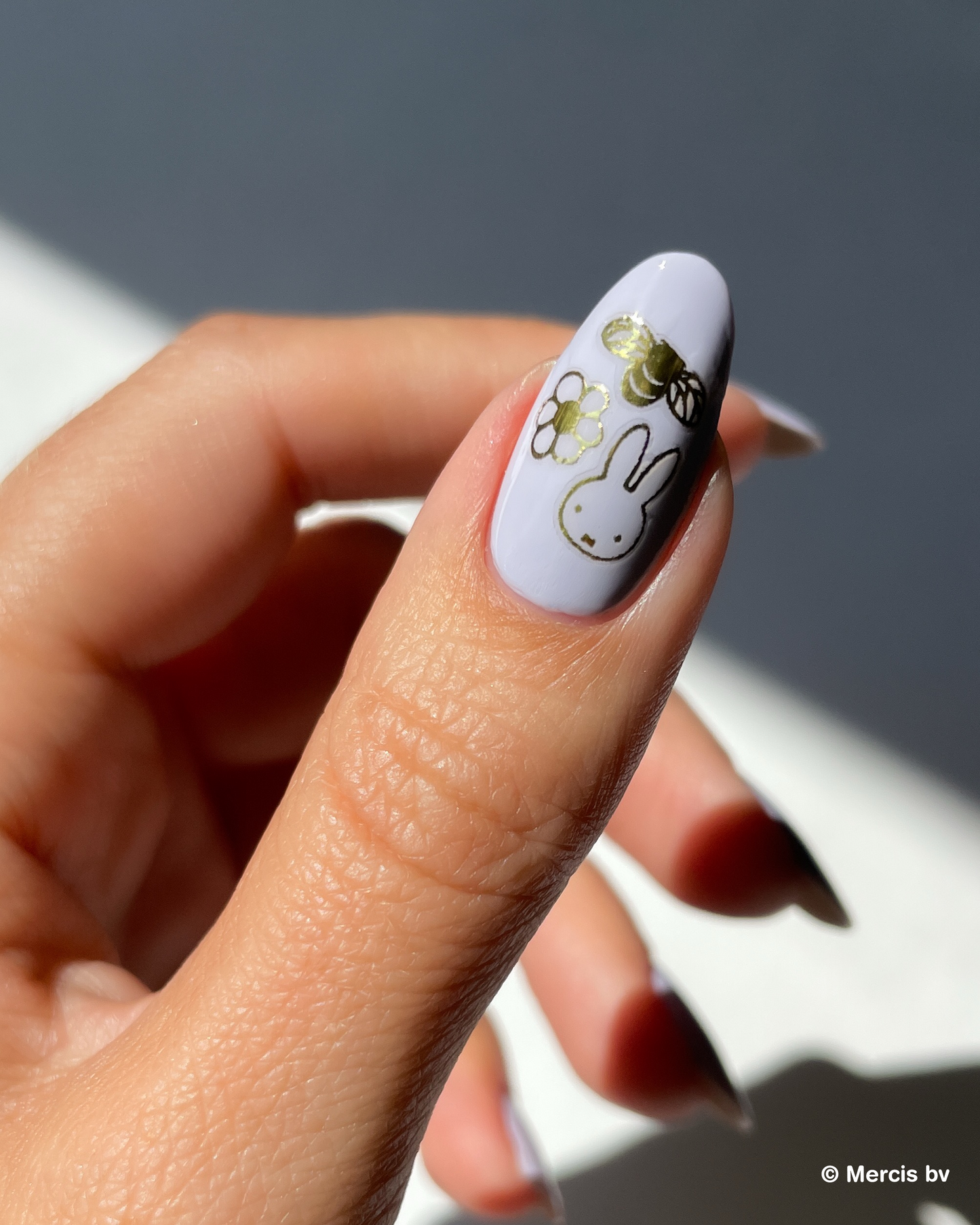 Nail with lavender nail polish and miffy nail art stickers