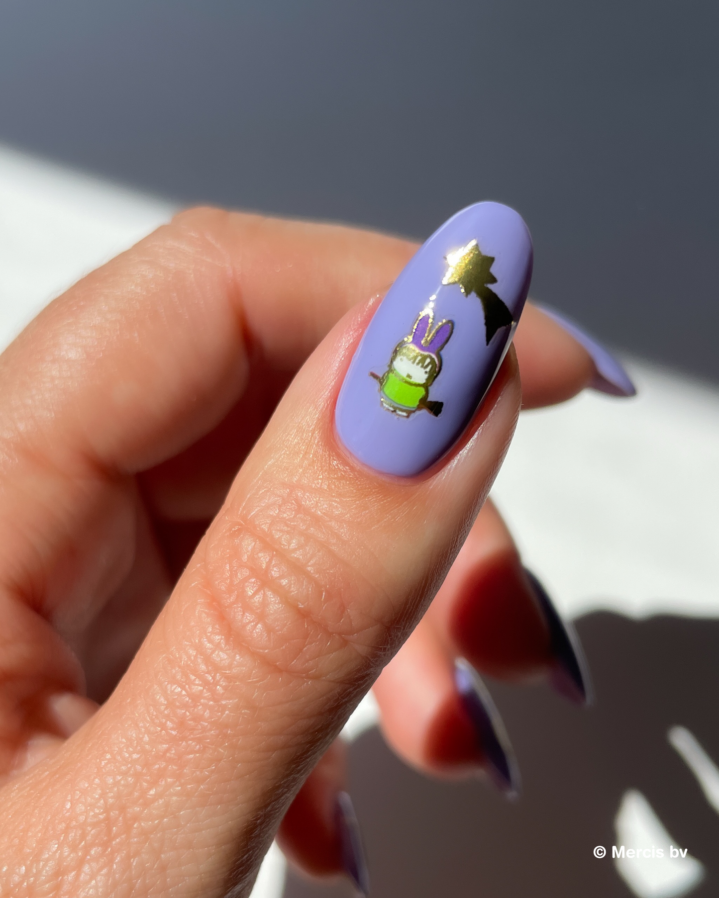 Nail with purple polish and miffy nail art sticker