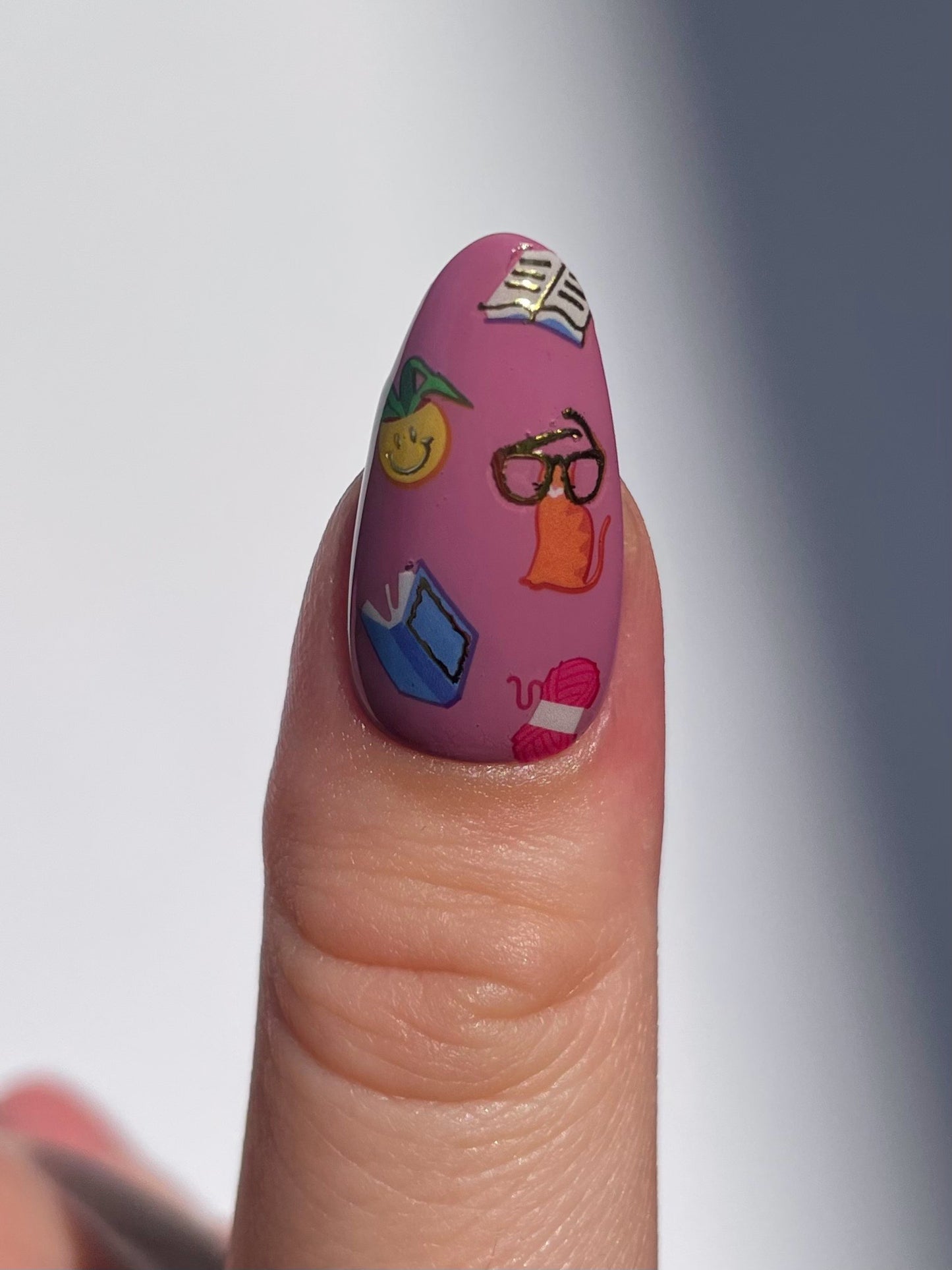 Stickerbook nails on a mauve pink base