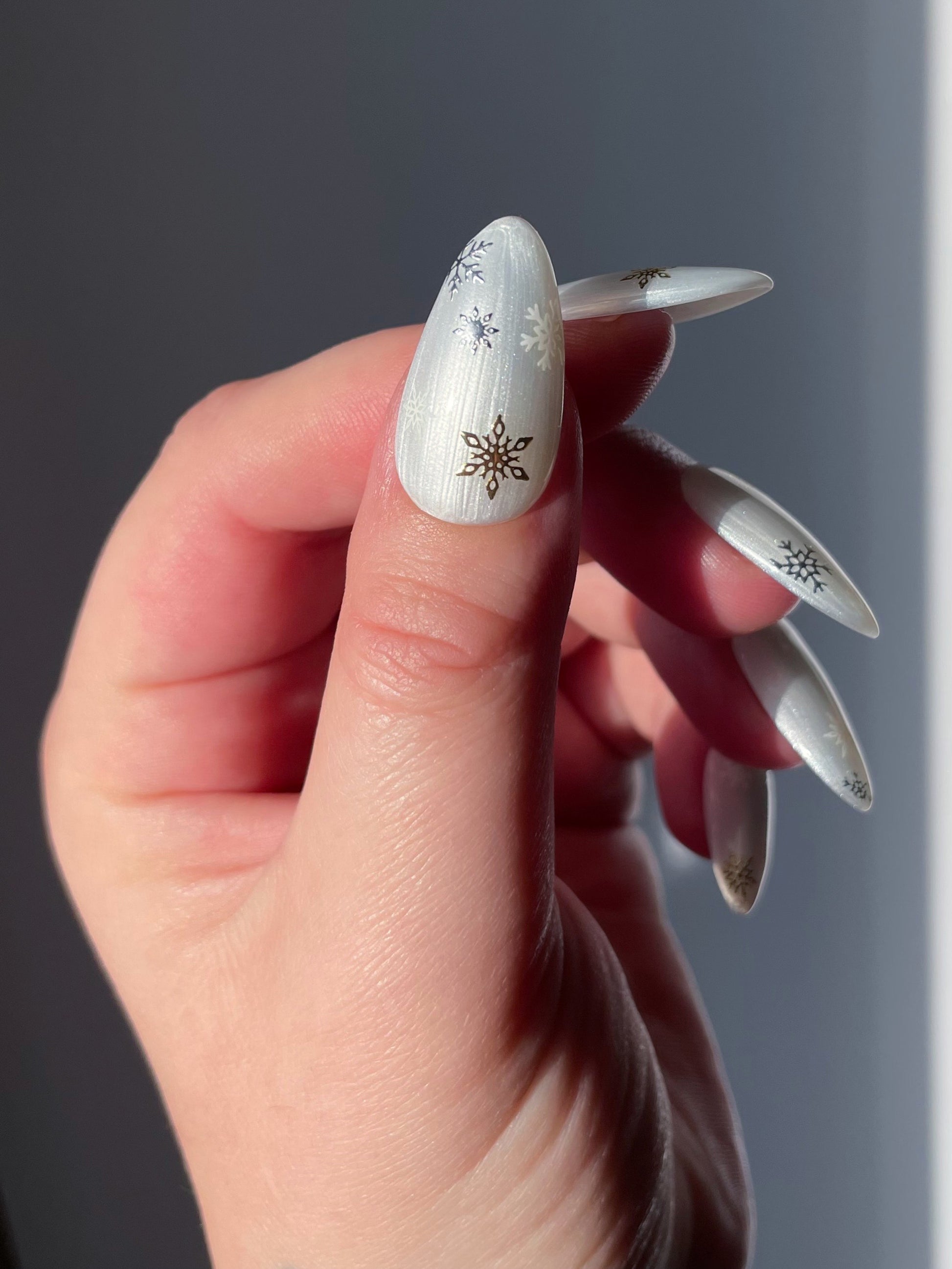 Snowfall stickers on a pearl white nail