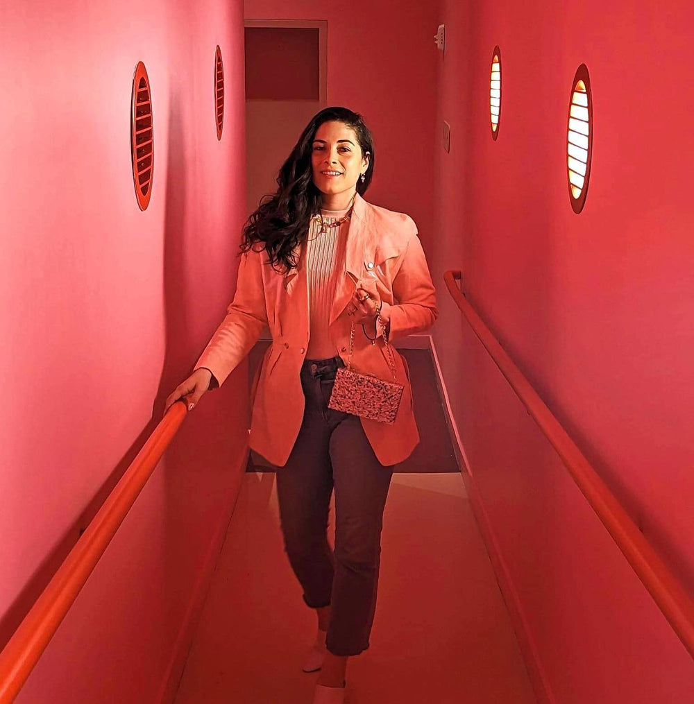 Jules in a pink hallway