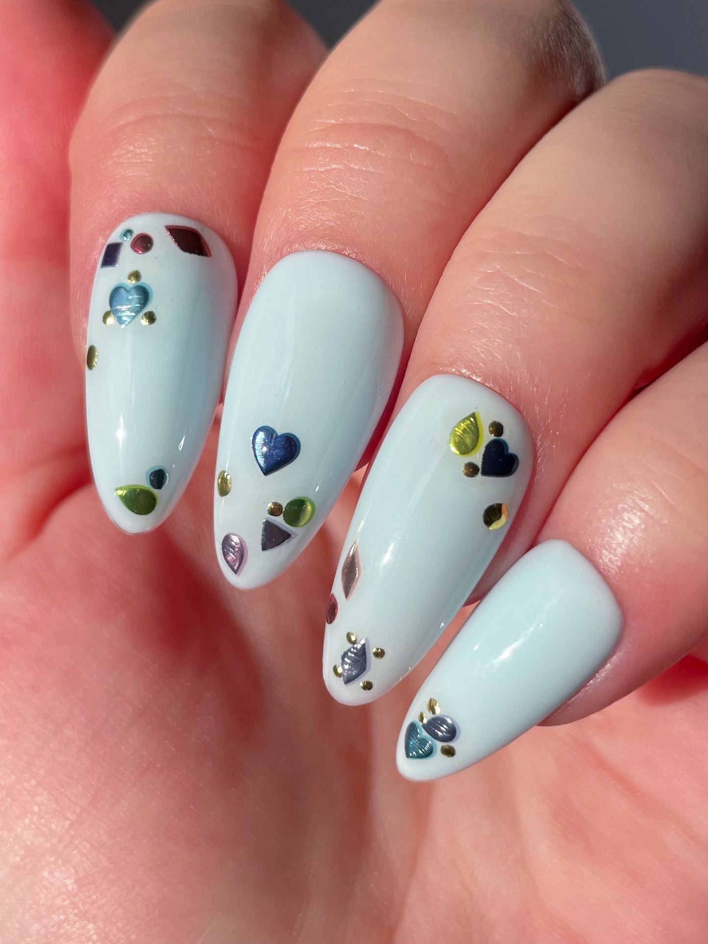 Topaz stickers on light blue nails