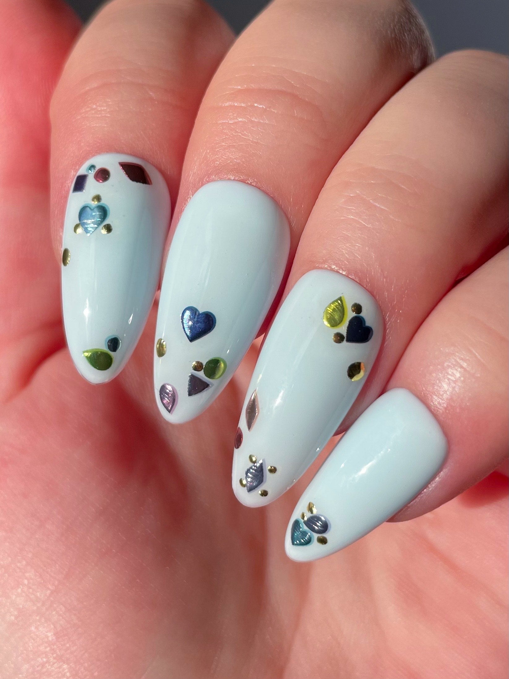 Topaz stickers on light blue nails