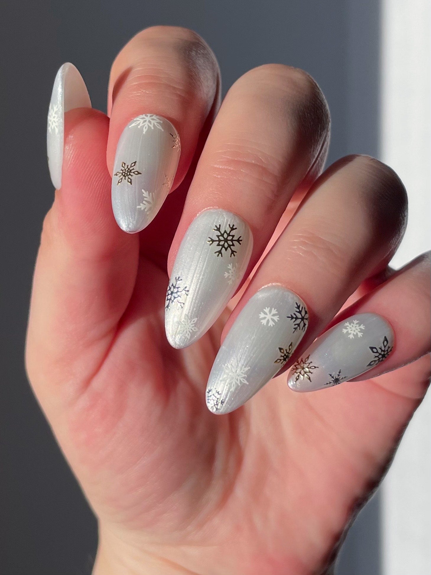 Snowfall stickers on pearl white nails