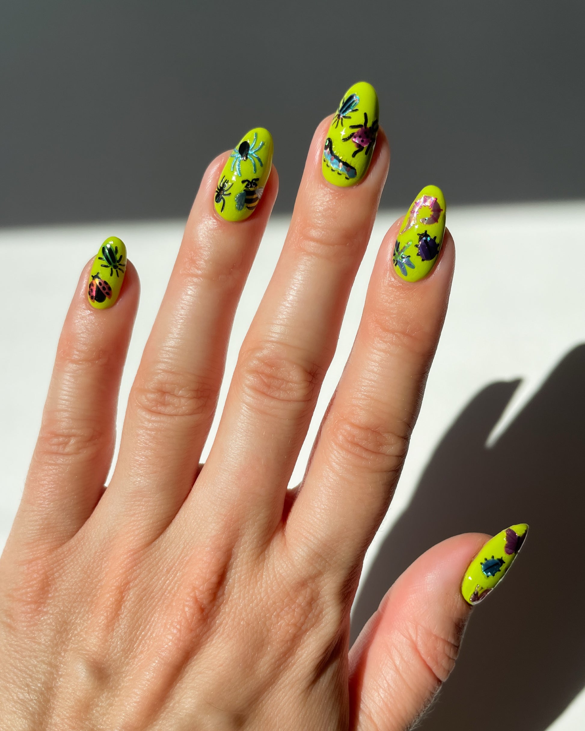 Bug Stickers on bright green nails