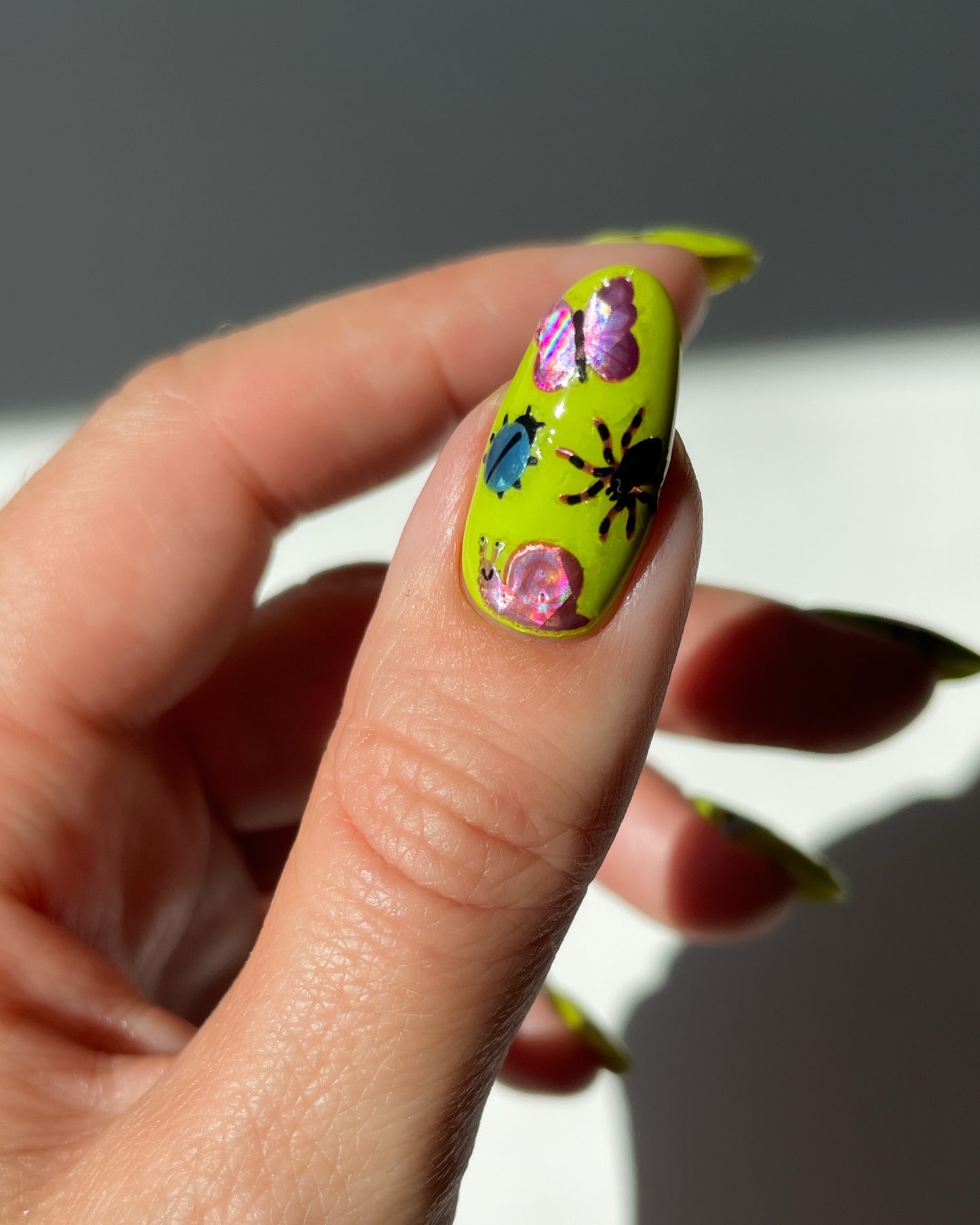 Bug Stickers on bright green nails