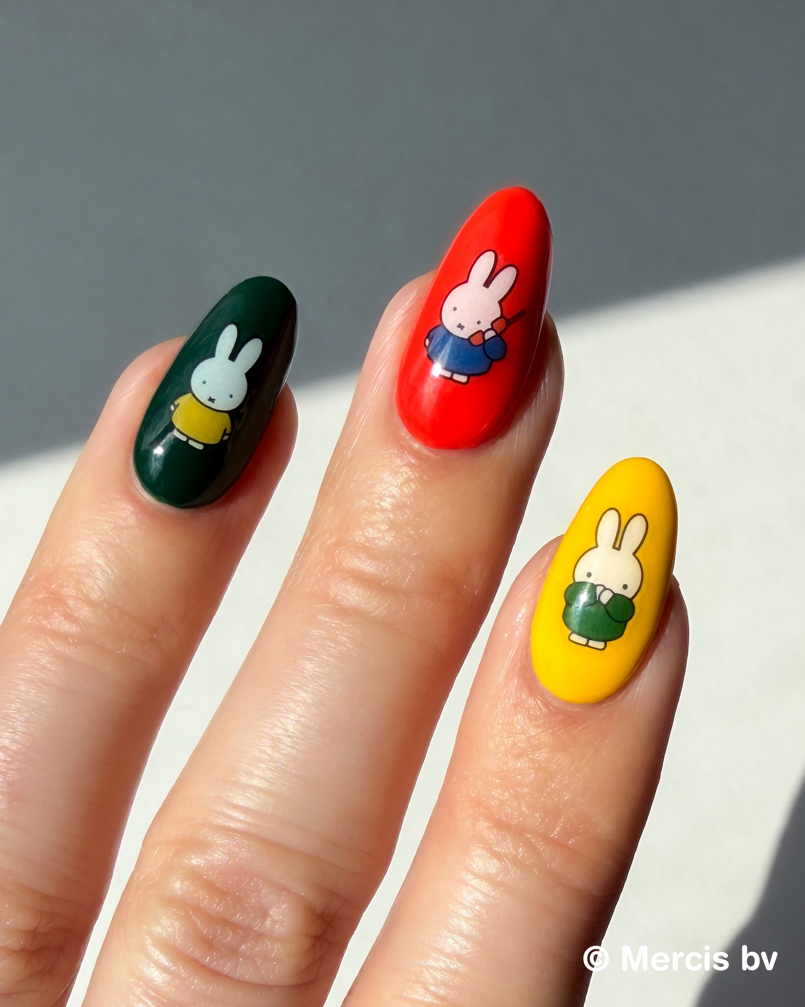 Nails with Miffy stickers on a neutral background