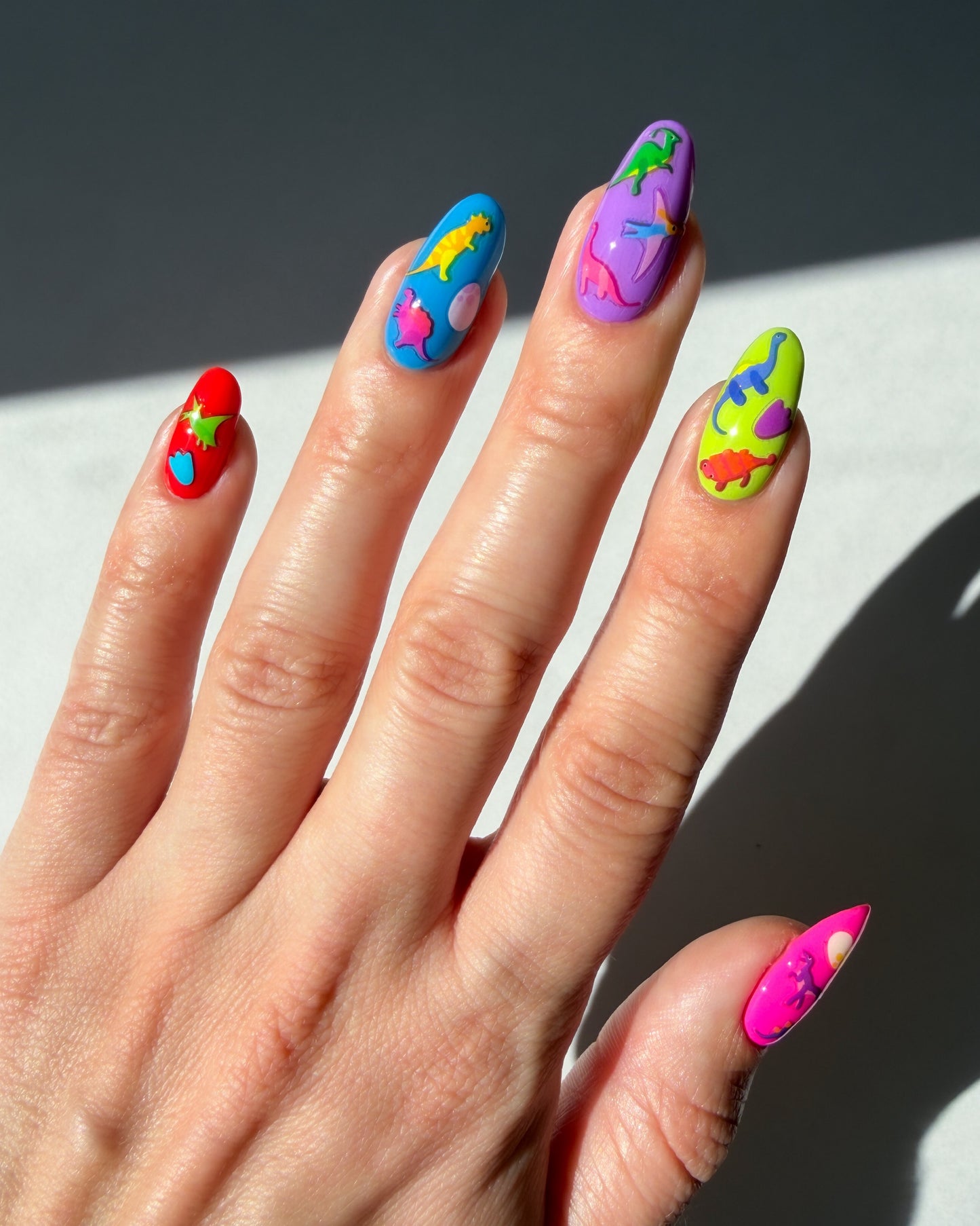 Dinos on neon multicolored nails