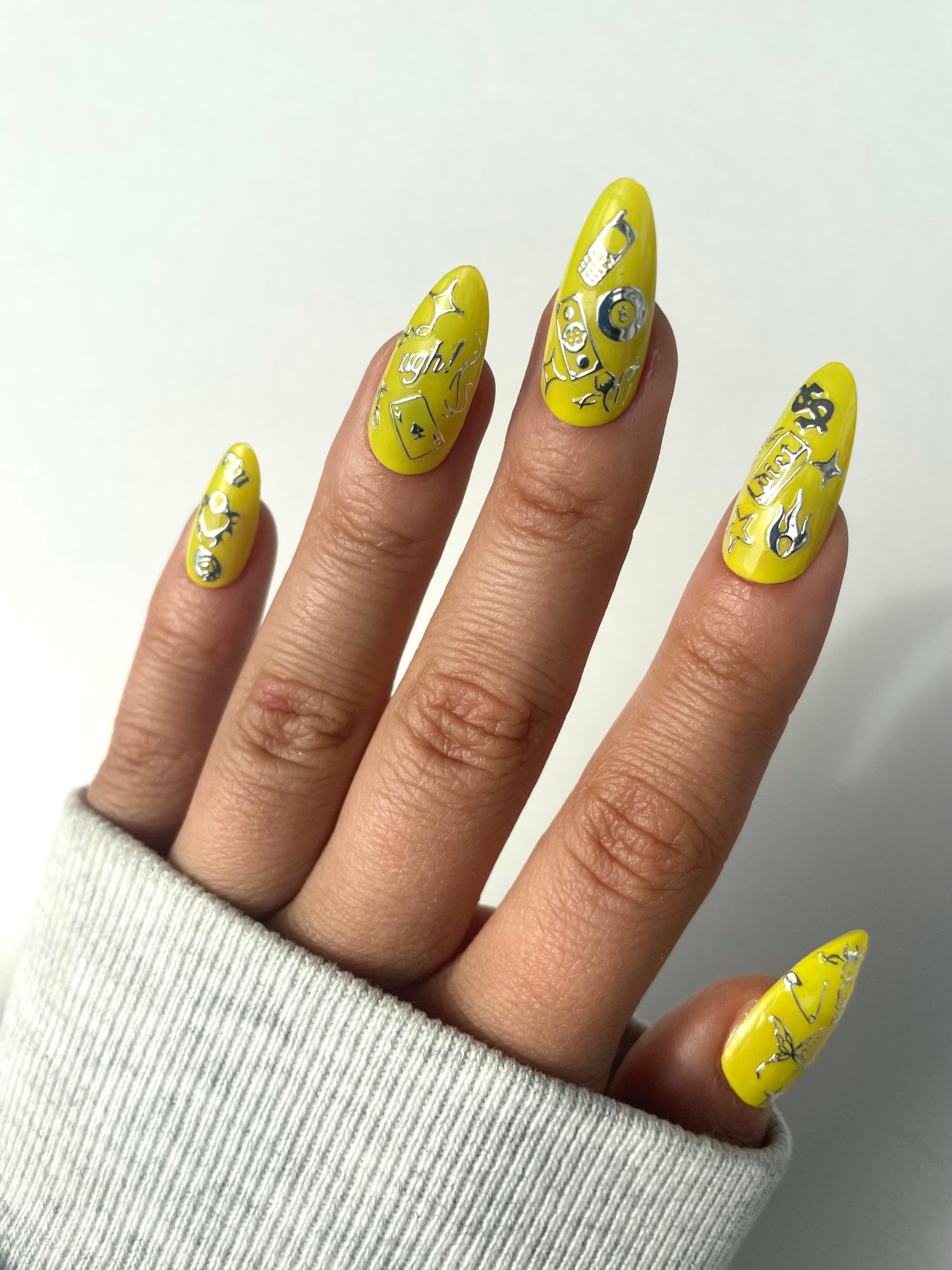 Rotten silver stickers on yellow nails
