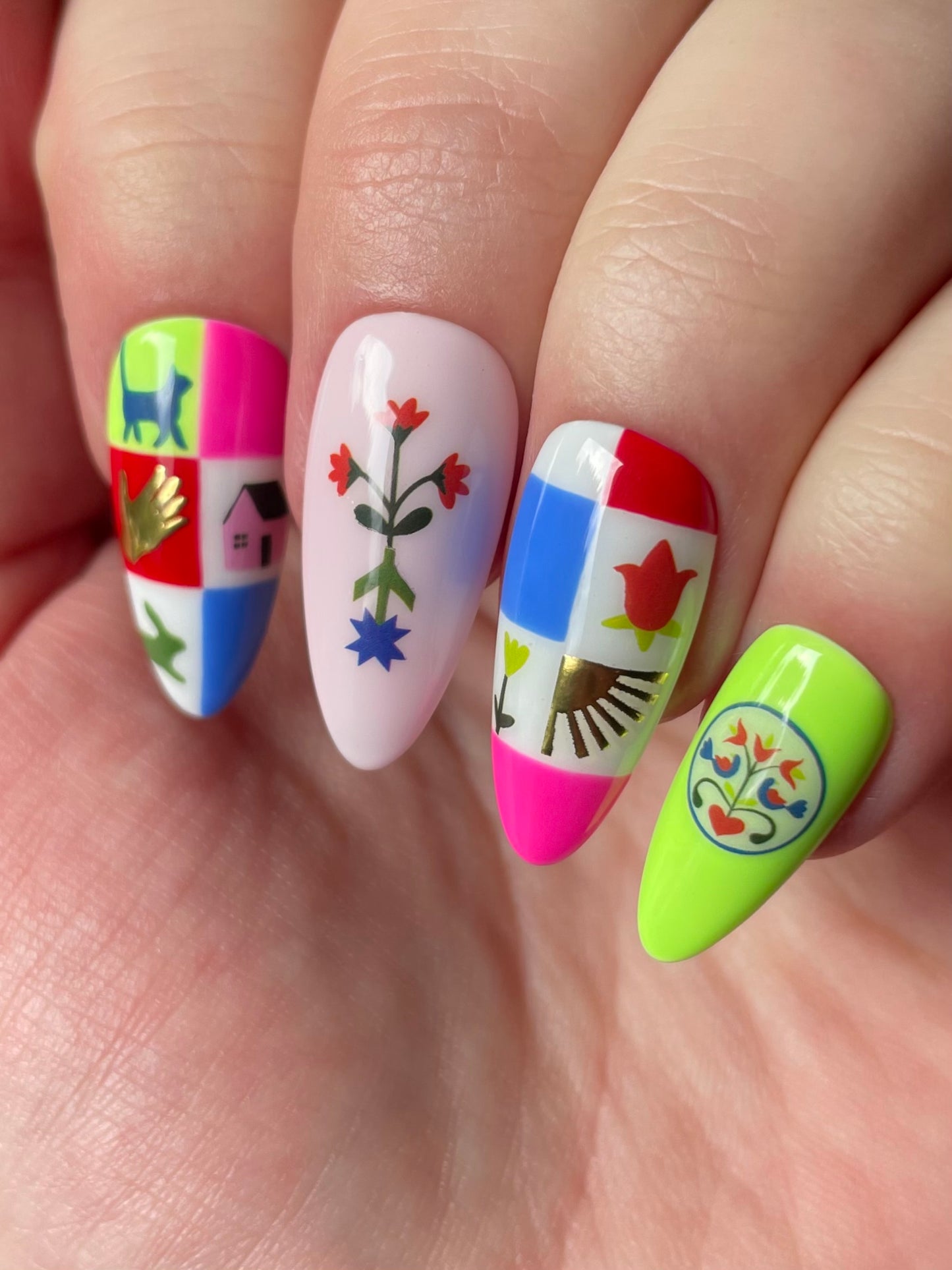 Close up of colorful nails featuring nail art stickers from the Pinwheel nail art sheet