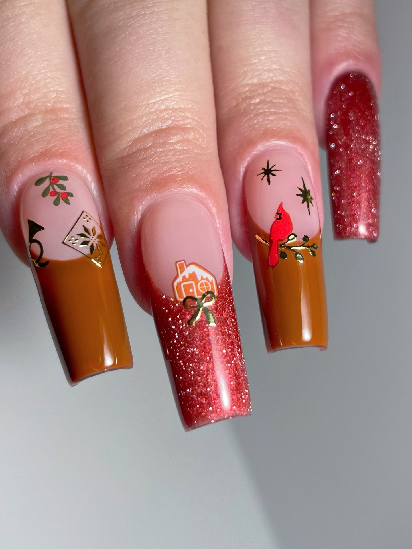 Deco The Hall stickers on brown and red french nails