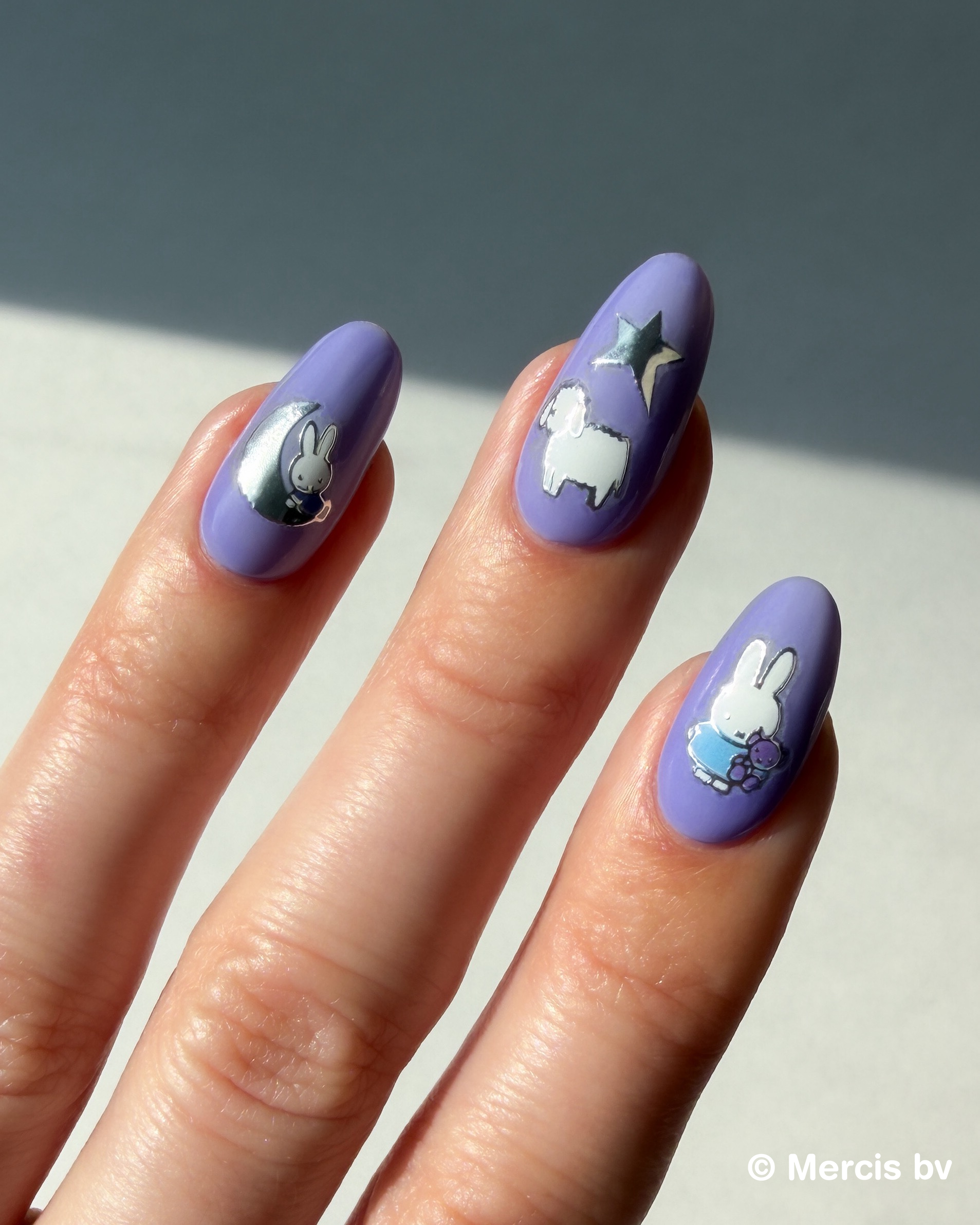 Nails with Miffy stickers on a neutral background