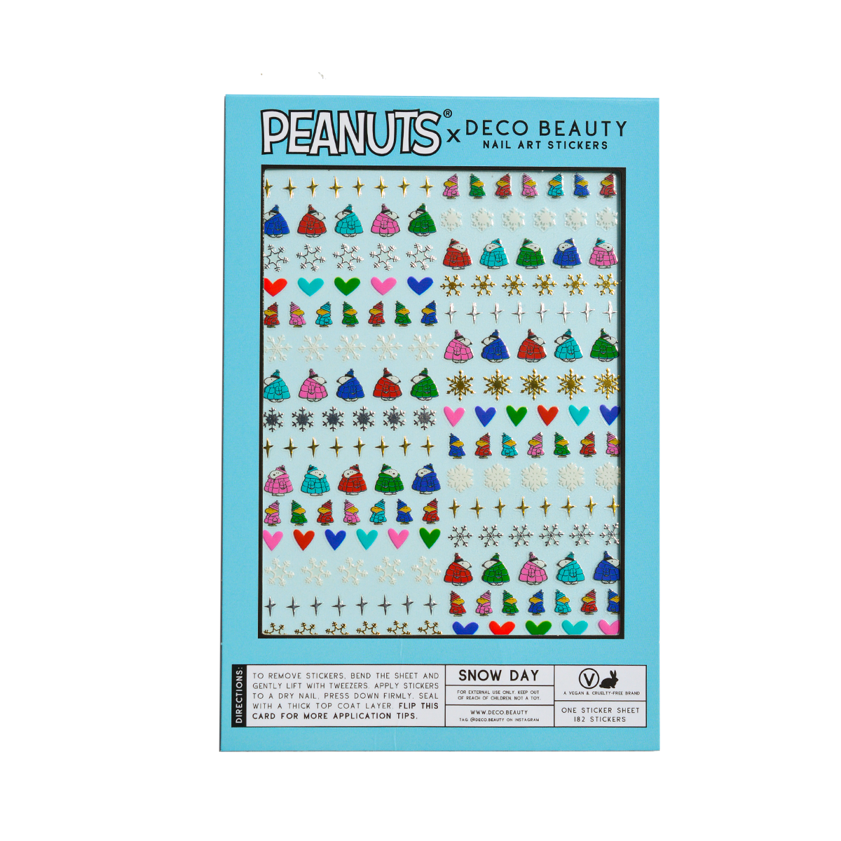 A flat lay of Peanuts x Deco Beauty 'Snow Day' nail art stickers, featuring colorful winter-themed stickers including snowflakes, hearts, Peanuts characters, and stars in light blue packaging.