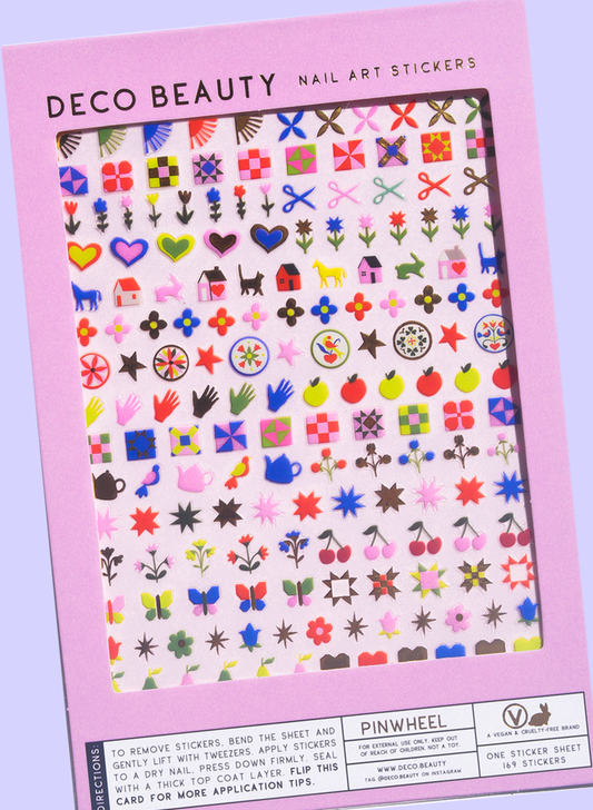 Pinwheel nail art sheet flat lay on a purple background