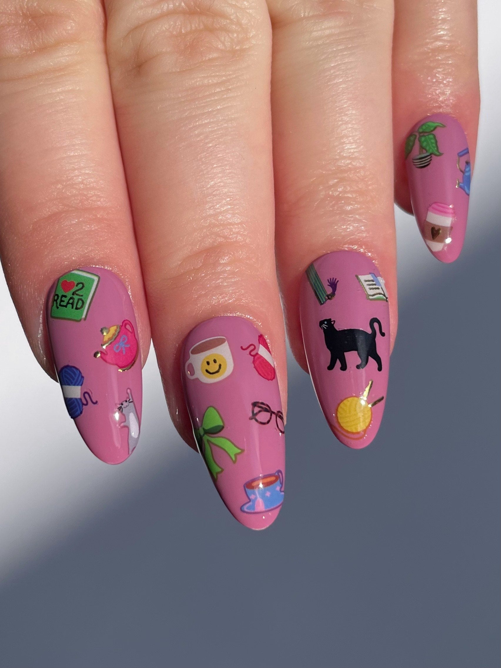 Stickerbook nails on a mauve pink base