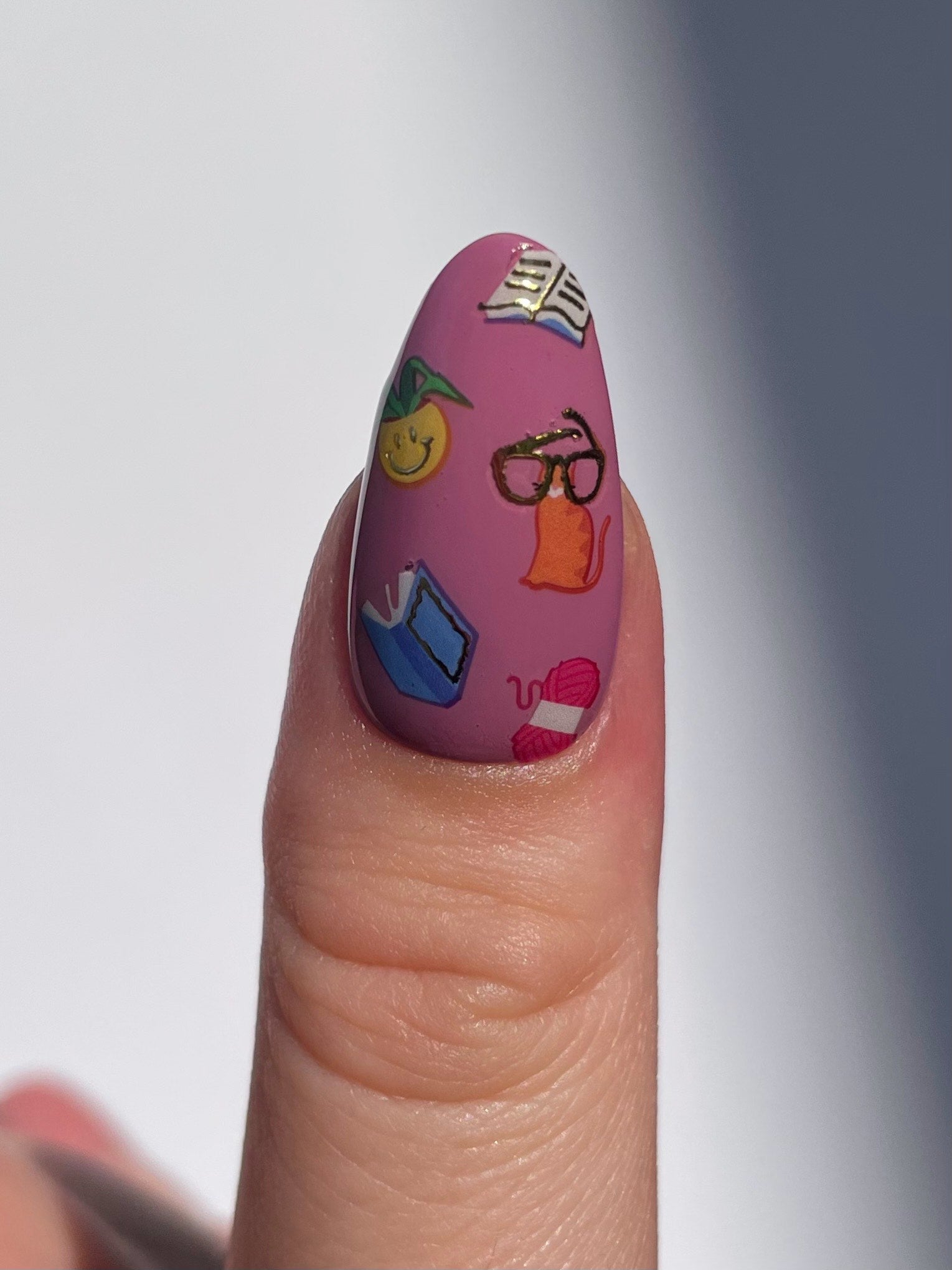 Stickerbook nails on a mauve pink base