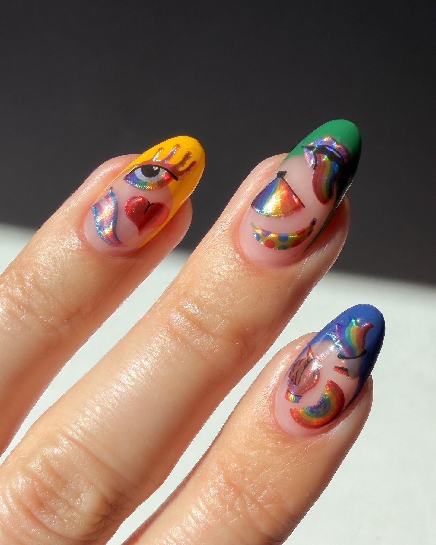 Nails with colorful designs on a dark background