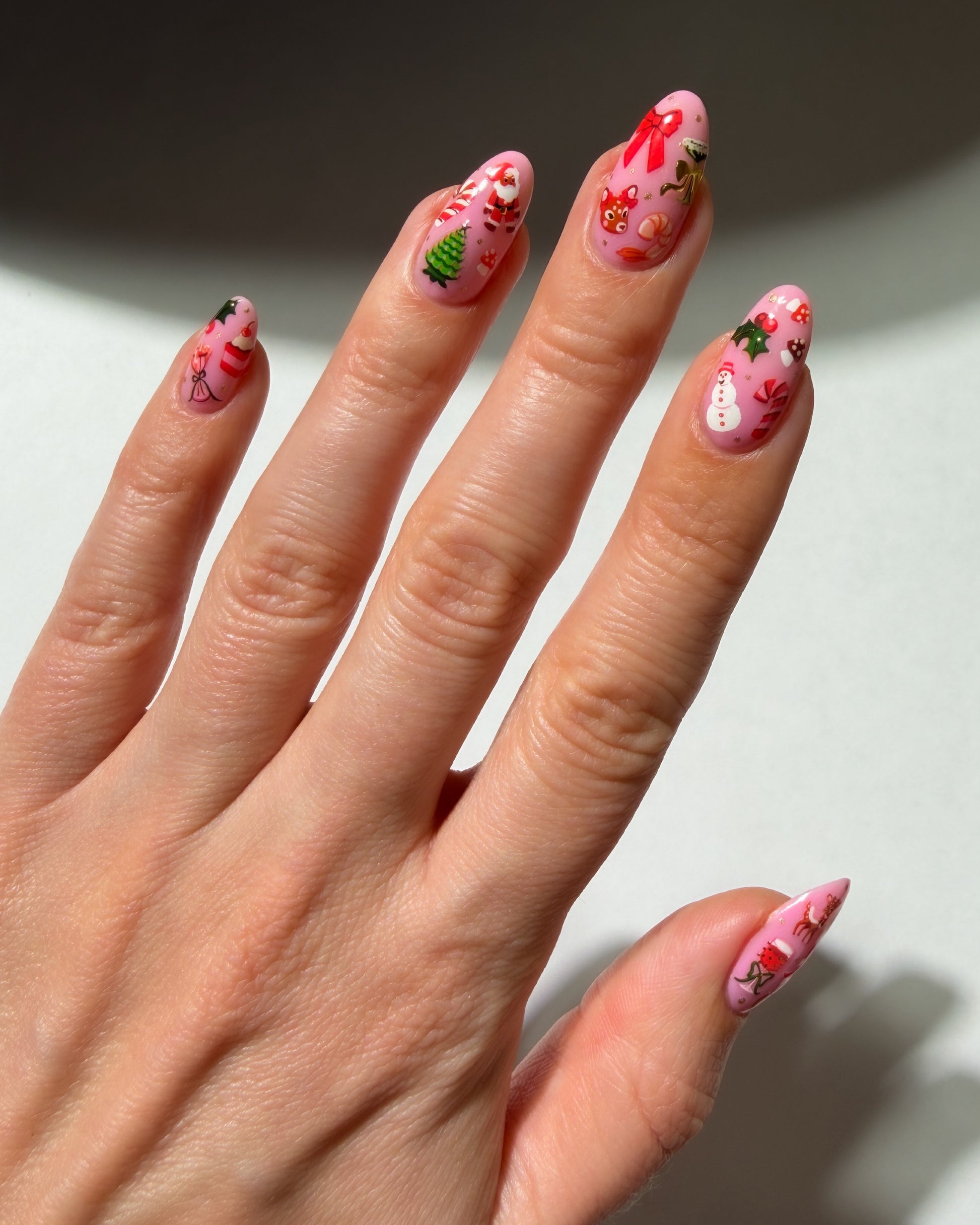 Santa Baby stickers on pink nails