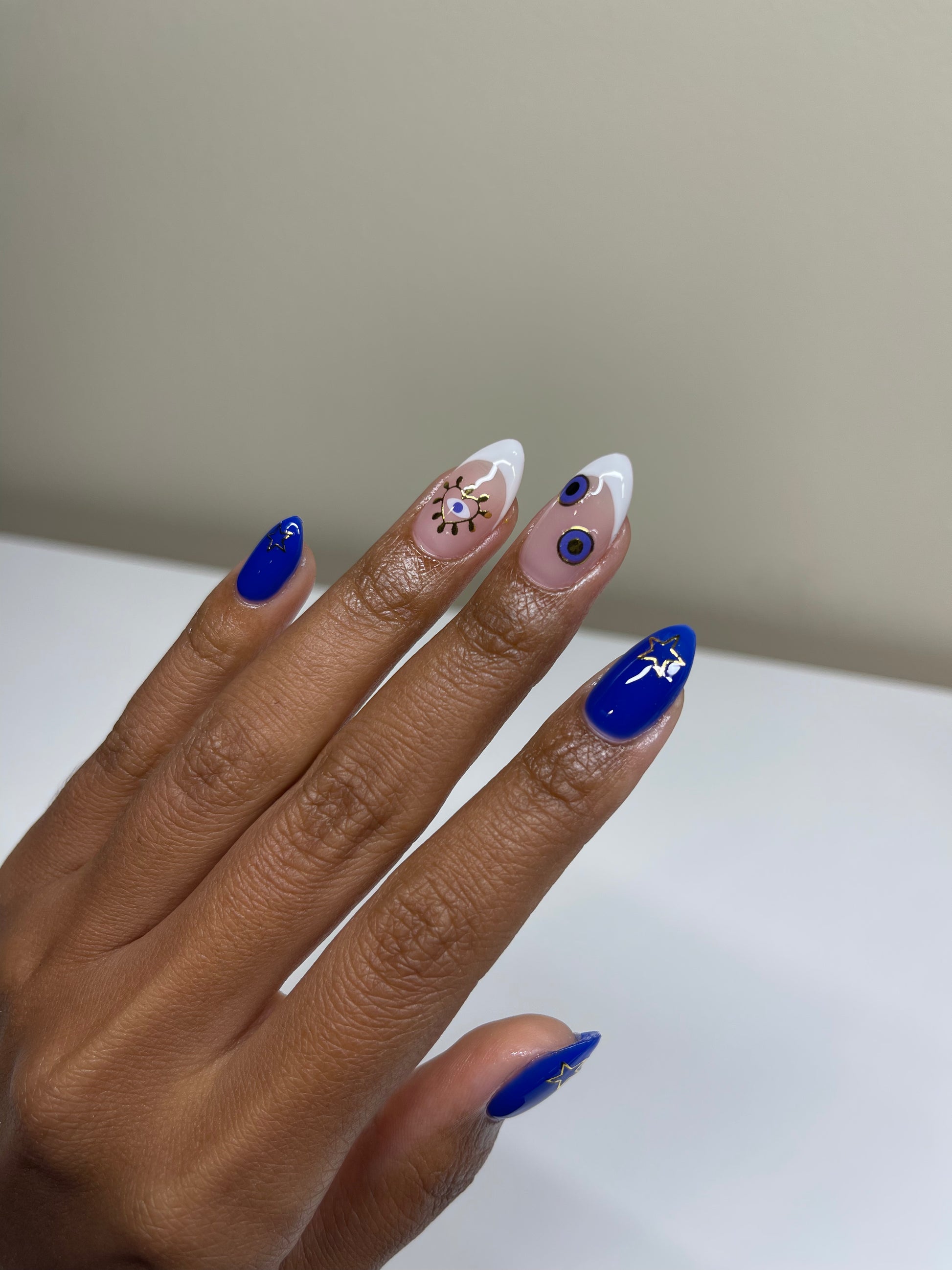 French tip and blue nails with stickers on