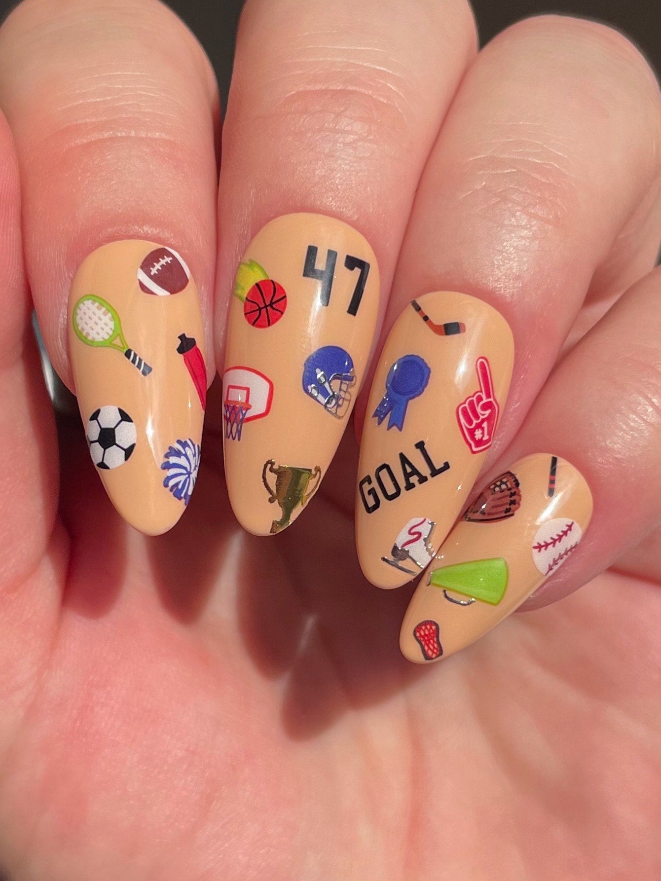 Stickerbook nails with Sports Ball stickers on beige nails
