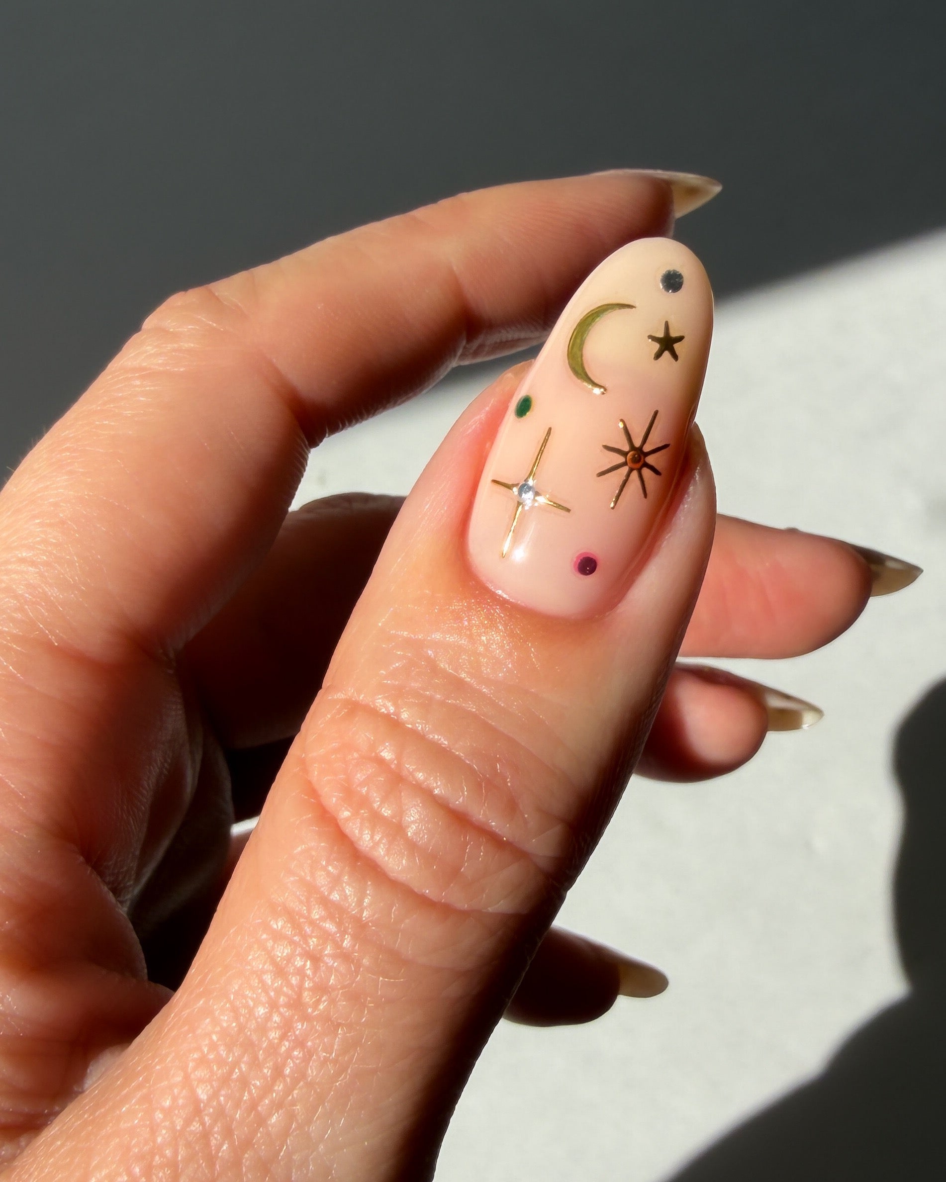 Stardust stickers on a nude nail