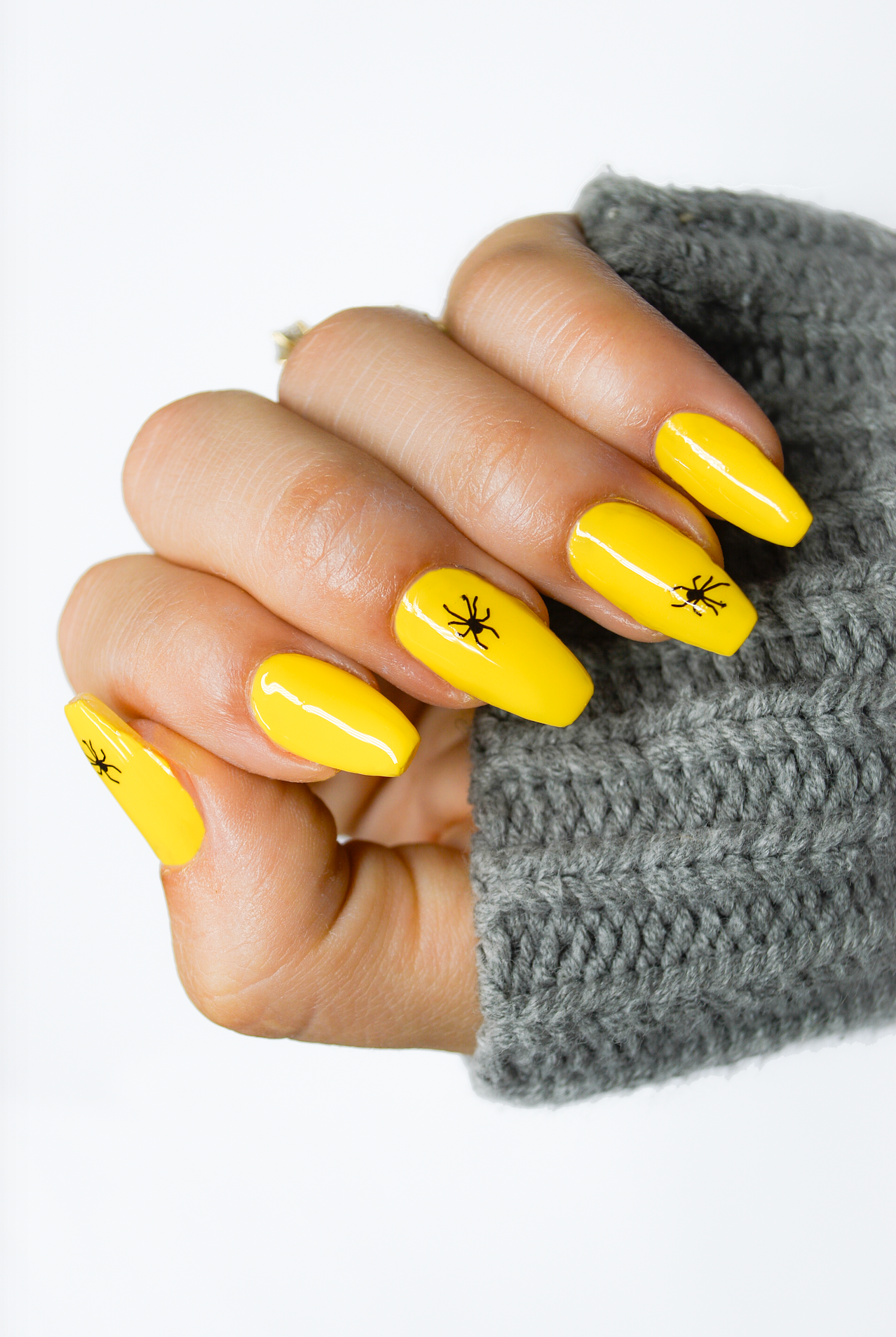yellow nails with spider stickers
