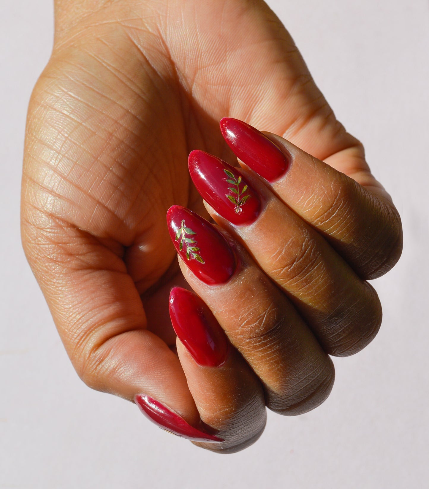 red nails with gold leaf stickers