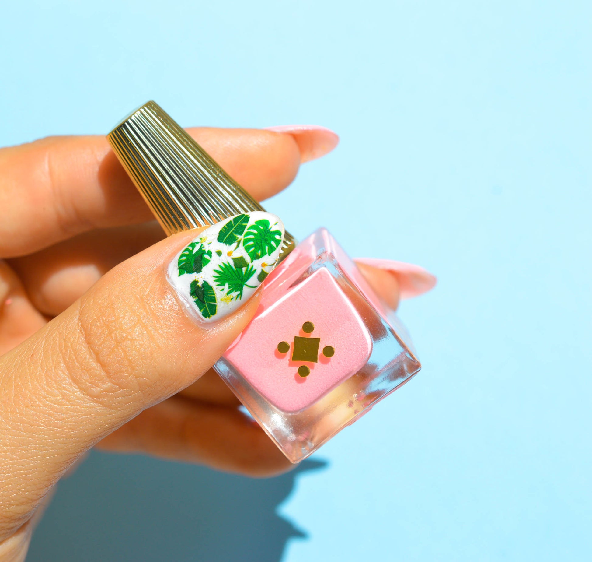 pink nails with green leaves on accent thumb