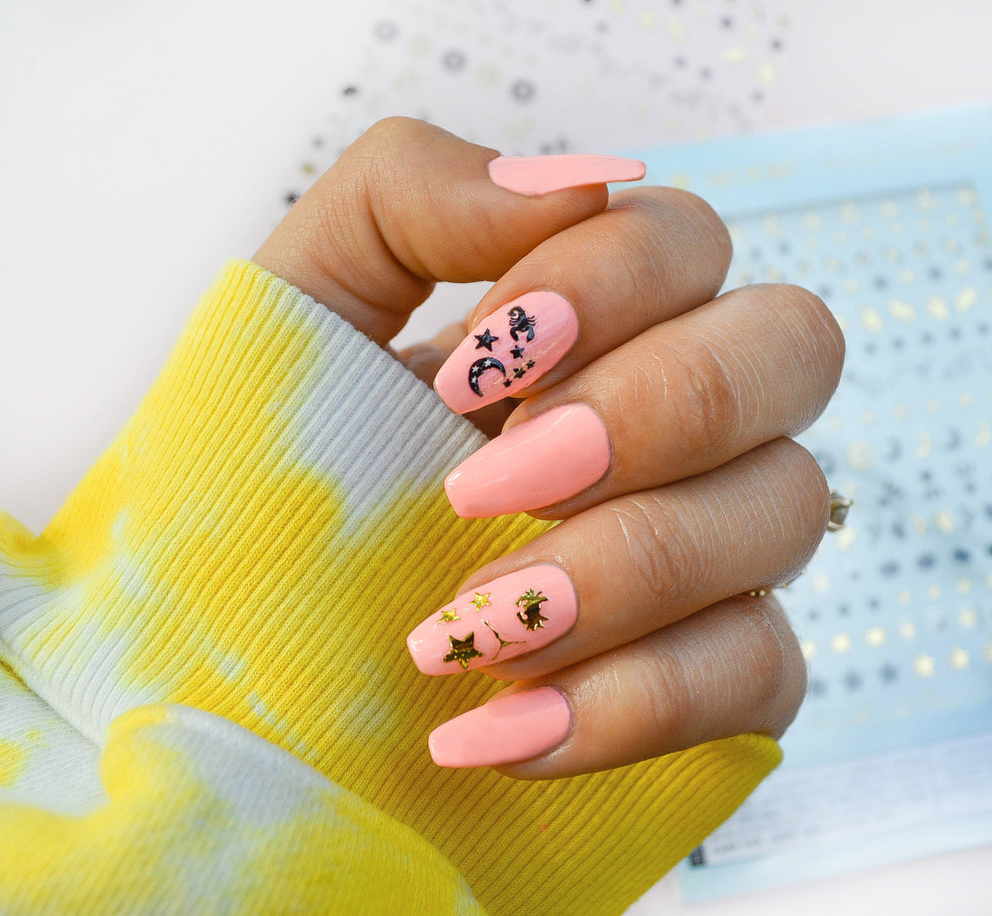 pink nails with scorpion, moon, star nail and gold crab star nail