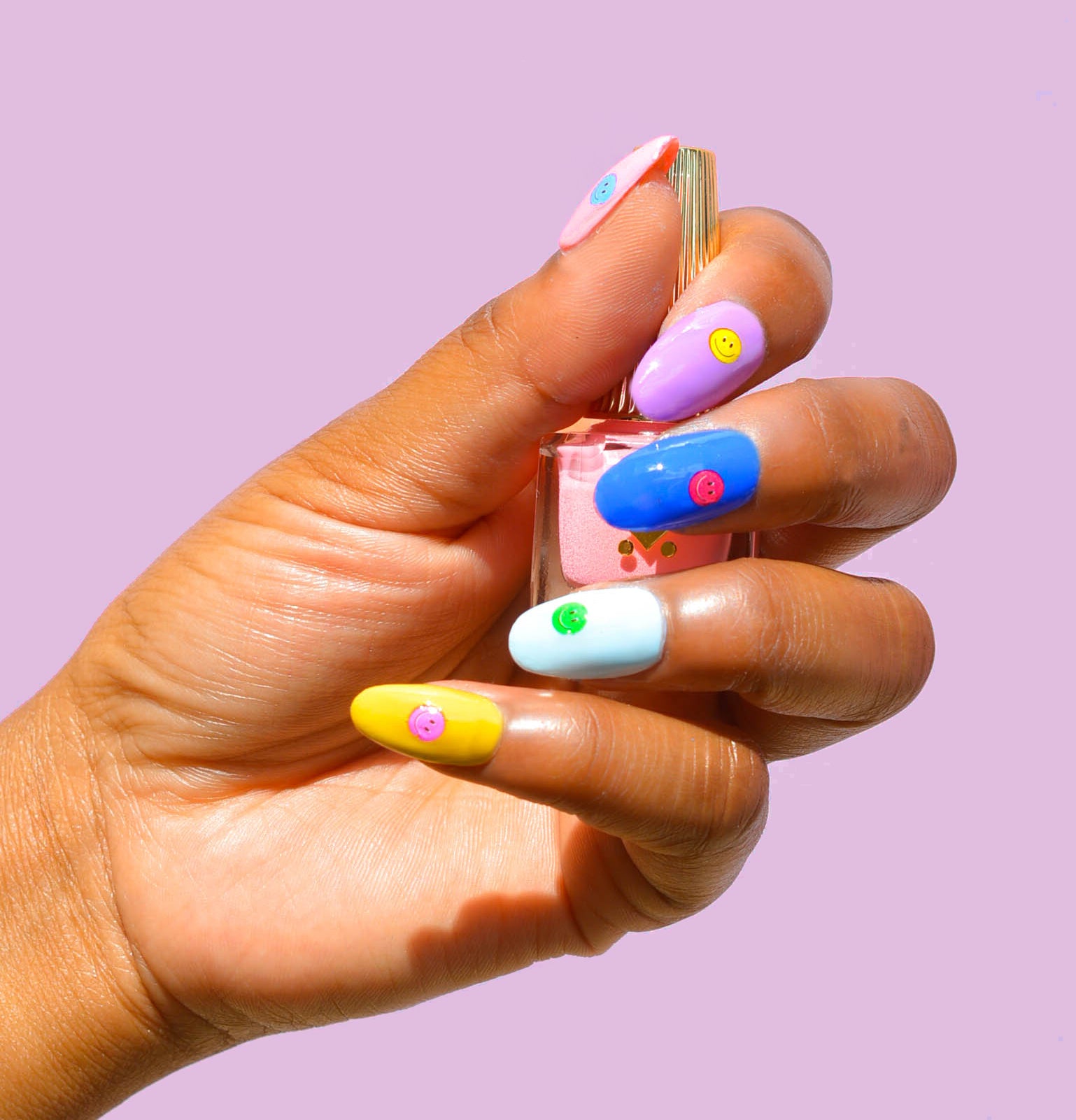 rainbow nails with smiley face art